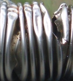 Fractured metal bellows due to overload